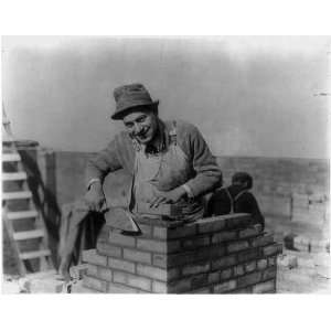  The bricklayer,Man laying bricks,smiling,c1915,coveralls 