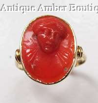 Antique carved red coral cameo ring in 18ct gold  