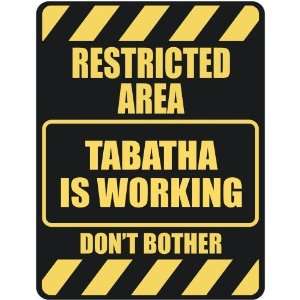   RESTRICTED AREA TABATHA IS WORKING  PARKING SIGN