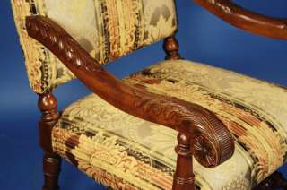   sinuous, carved mahogany armrests are as sturdy as they are beautiful