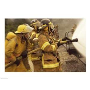  Side profile of a group of firefighters holding water 