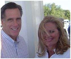 Casual photograph of Mitt and Ann Romney outdoors with wind blowing 